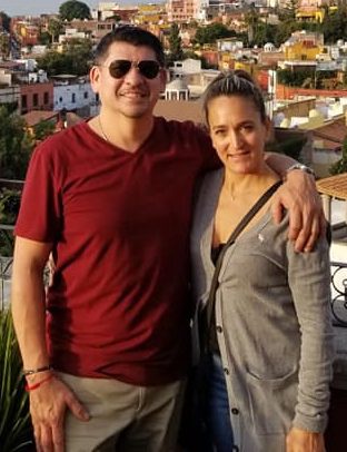 A man and woman standing next to each other.